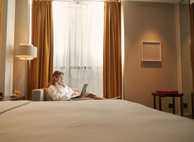 Normal_hotel-visitor-with-laptop-on-sofa-in-room-2022-02-28-23-31-18-utc
