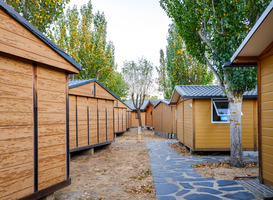 Normal_wooden-bungalows-lined-up-in-a-village-2022-05-04-00-48-12-utc