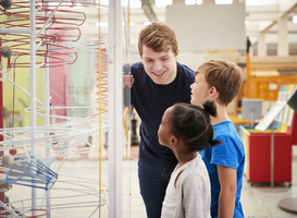 Normal_teacher-and-kids-talking-about-a-science-exhibit-2021-08-26-16-14-36-utc