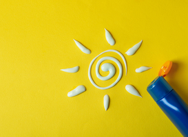 Normal_sun-made-of-sunscreen-and-bottle-of-cream-on-yello-2022-02-05-00-38-04-utc