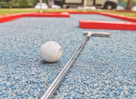 Normal_a-golf-ball-and-golf-club-lay-on-an-outdoor-mini-g-2022-11-01-04-36-06-utc